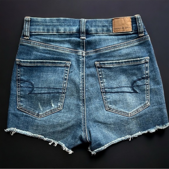 AE Next Level Stretch Curvy High Rise Shortie Distressed Denim Shorts - Picture 4 of 10